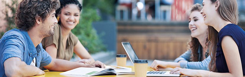 Students with textbooks, coffee and laptops