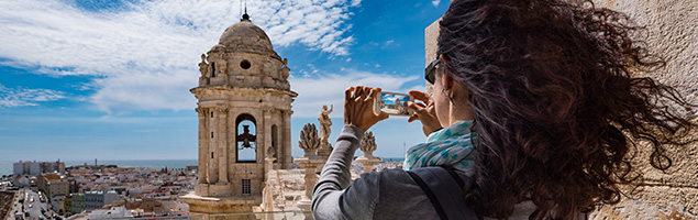 Woman taking a picture of Cadiz